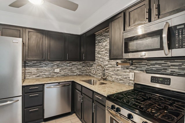 5525 N Chester Ave Unit 46, Chicago, IL 60656 - kitchen featuring appliances with stainless steel finishes, ceiling fan, decorative backsplash, light stone counters, and crown molding