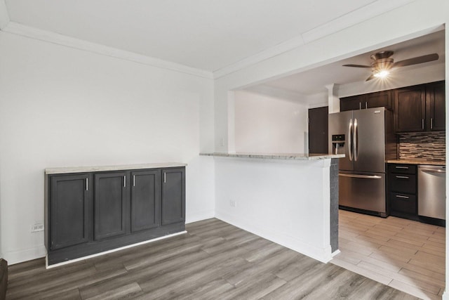 5525 N Chester Ave Unit 46, Chicago, IL 60656 - kitchen with appliances with stainless steel finishes, ornamental molding, decorative backsplash, ceiling fan, and light wood-style flooring
