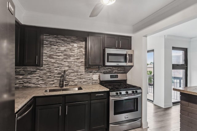 5525 N Chester Ave Unit 46, Chicago, IL 60656 - kitchen with appliances with stainless steel finishes, backsplash, a ceiling fan, crown molding, and light wood-type flooring