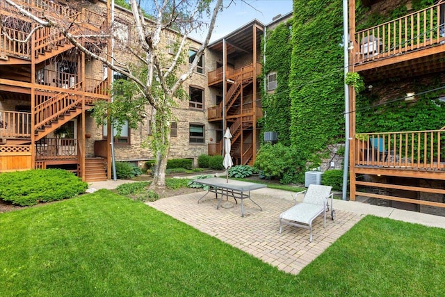 1023 N Hoyne Ave Unit 3B, Chicago, IL 60622 - view of grassy yard featuring stairs and a patio