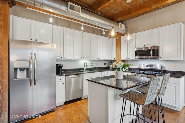 1740 N Maplewood Ave Unit 416, Chicago, IL 60647 - kitchen with stainless steel appliances, light wood-type flooring, white cabinetry, and a wood ceiling with exposed beams