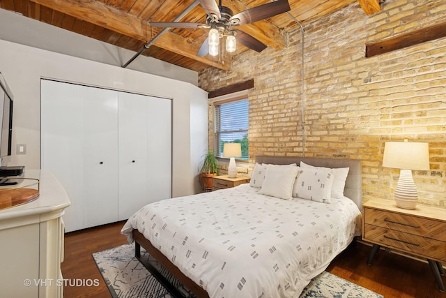 1740 N Maplewood Ave Unit 416, Chicago, IL 60647 - bedroom with a wooden ceiling with exposed beams, brick wall, a closet, wood finished floors, and a ceiling fan