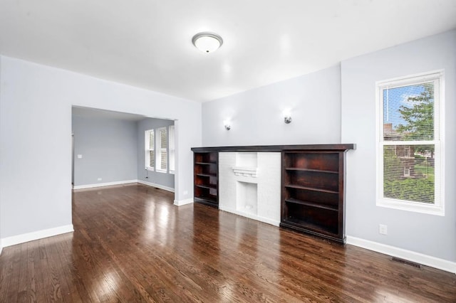 8521 S Loomis Blvd, Chicago, IL 60620 - unfurnished living room featuring wood finished floors, healthy amount of natural light, and a fireplace