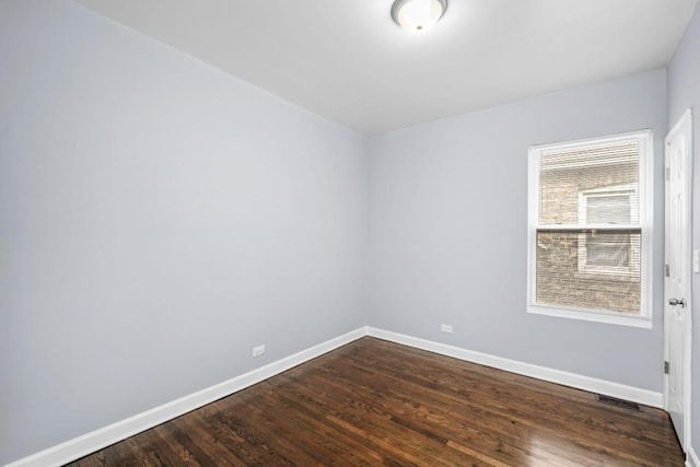 8521 S Loomis Blvd, Chicago, IL 60620 - unfurnished room featuring baseboards and dark wood-type flooring
