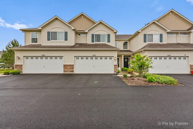 392 S Jade Ln, Round Lake, IL 60073 - multi unit property with asphalt driveway, a garage, and stone siding