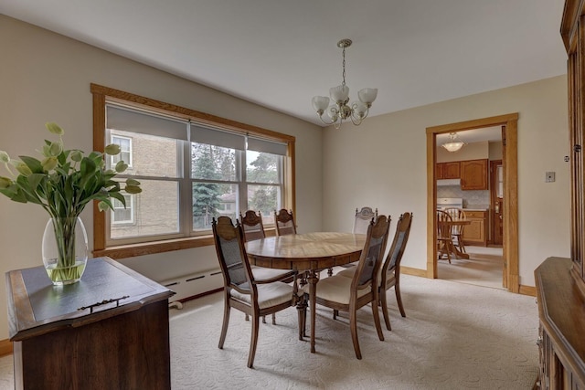 4934 N Marmora Ave, Chicago, IL 60630 - dining area featuring light colored carpet, a chandelier, and baseboard heating