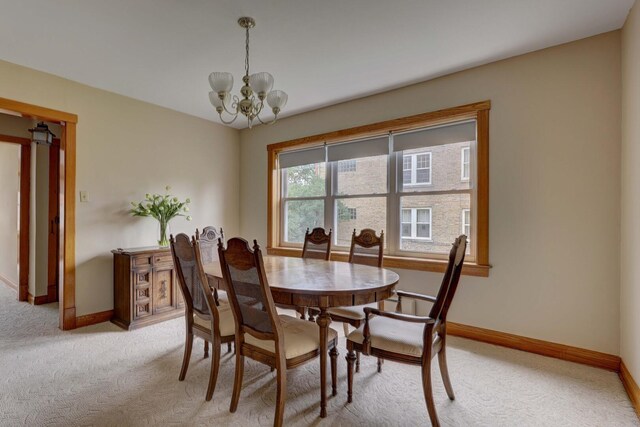 4934 N Marmora Ave, Chicago, IL 60630 - dining space with light carpet and a chandelier