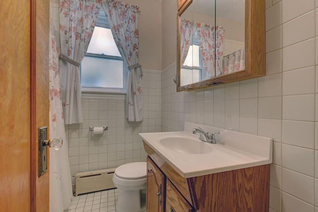 4934 N Marmora Ave, Chicago, IL 60630 - bathroom with a baseboard radiator, tile walls, vanity, and tile patterned flooring