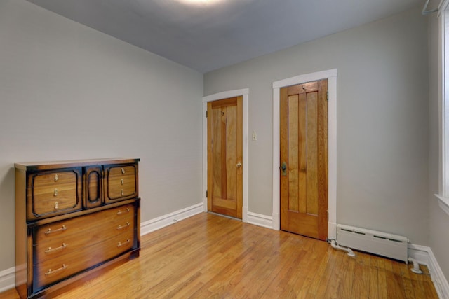 4934 N Marmora Ave, Chicago, IL 60630 - bedroom with a baseboard heating unit and light wood-style floors