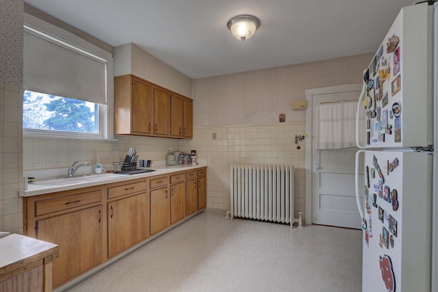4934 N Marmora Ave, Chicago, IL 60630 - kitchen featuring radiator heating unit, freestanding refrigerator, light countertops, tile walls, and light flooring