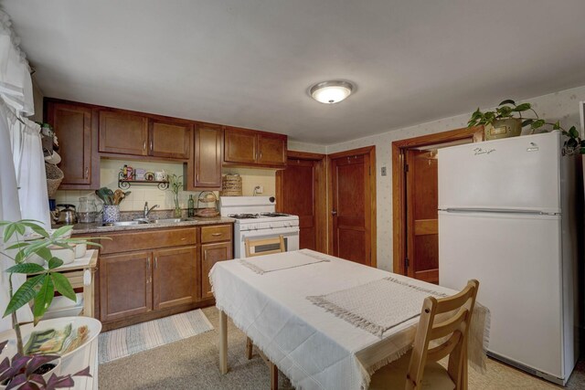 4934 N Marmora Ave, Chicago, IL 60630 - kitchen featuring white appliances, light colored carpet, and brown cabinets