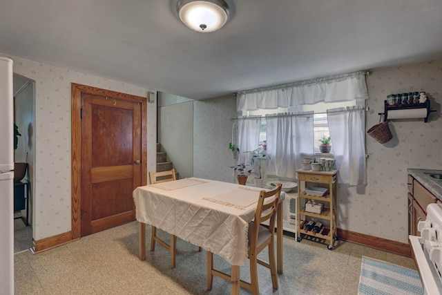 4934 N Marmora Ave, Chicago, IL 60630 - dining space featuring wallpapered walls and stairs