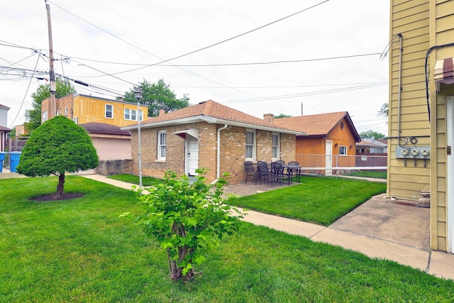 4934 N Marmora Ave, Chicago, IL 60630 - rear view of property featuring brick siding and a patio area