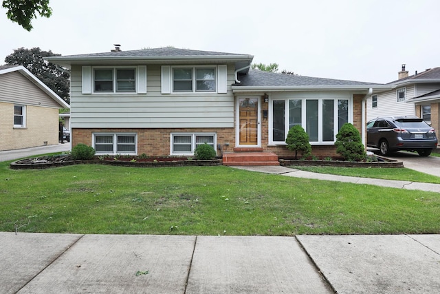 1065 Irwin Ave, Des Plaines, IL 60018 - split level home with a front yard, brick siding, and entry steps