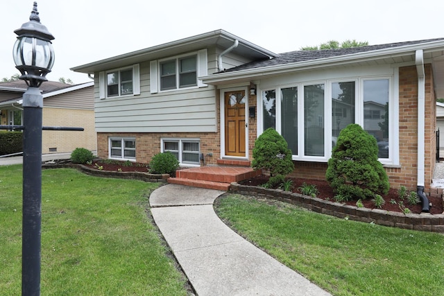 1065 Irwin Ave, Des Plaines, IL 60018 - tri-level home featuring brick siding and a front lawn