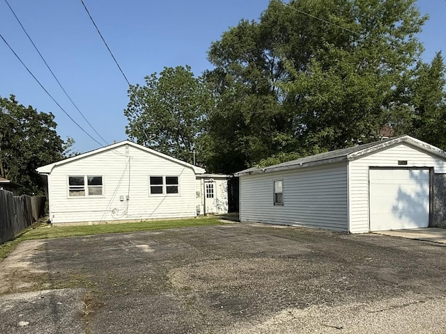 2524 Gilboa Ave, Zion, IL 60099 - back of house with asphalt driveway, an outdoor structure, and a detached garage