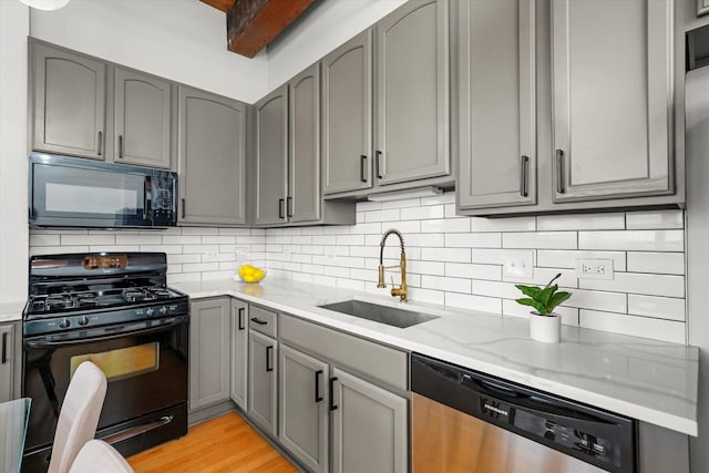 1503 S State St Unit 501, Chicago, IL 60605 - kitchen featuring black appliances, gray cabinets, light stone counters, and tasteful backsplash