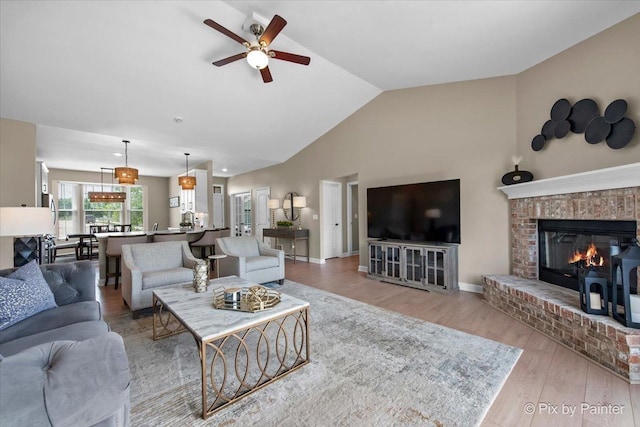 2213 Tyler Trl, Mchenry, IL 60051 - living room featuring a ceiling fan, wood finished floors, a brick fireplace, and high vaulted ceiling