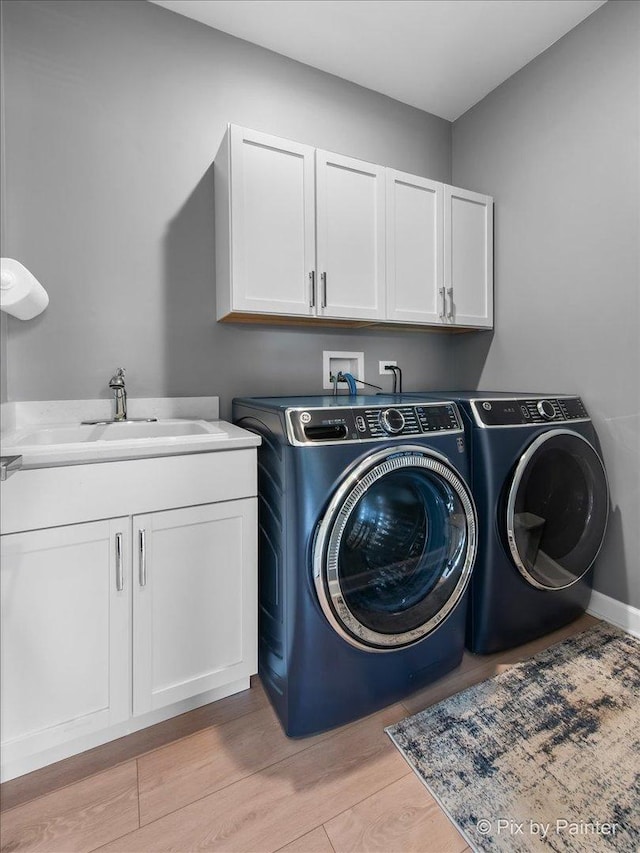2213 Tyler Trl, Mchenry, IL 60051 - laundry room with cabinet space, separate washer and dryer, and light wood-style floors