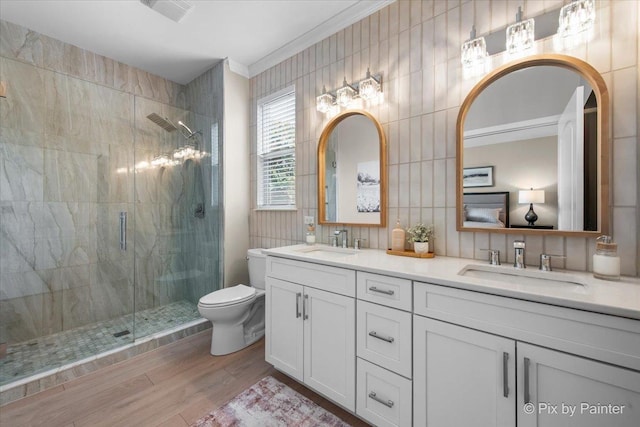 2213 Tyler Trl, Mchenry, IL 60051 - bathroom featuring double vanity, a shower stall, wood finished floors, and ornamental molding