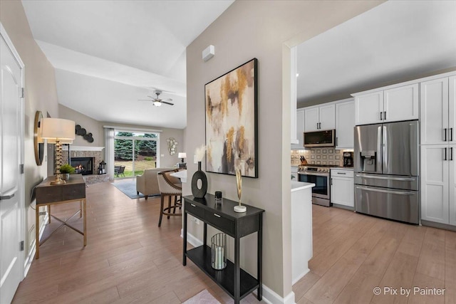 2213 Tyler Trl, Mchenry, IL 60051 - hallway featuring light wood finished floors and vaulted ceiling