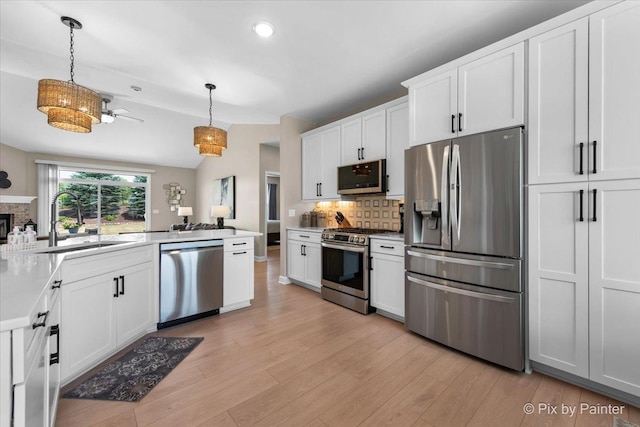 2213 Tyler Trl, Mchenry, IL 60051 - kitchen with appliances with stainless steel finishes, backsplash, light wood-style floors, decorative light fixtures, and recessed lighting