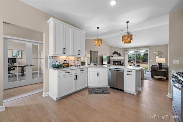 2213 Tyler Trl, Mchenry, IL 60051 - kitchen with appliances with stainless steel finishes, open floor plan, a peninsula, light countertops, and white cabinets
