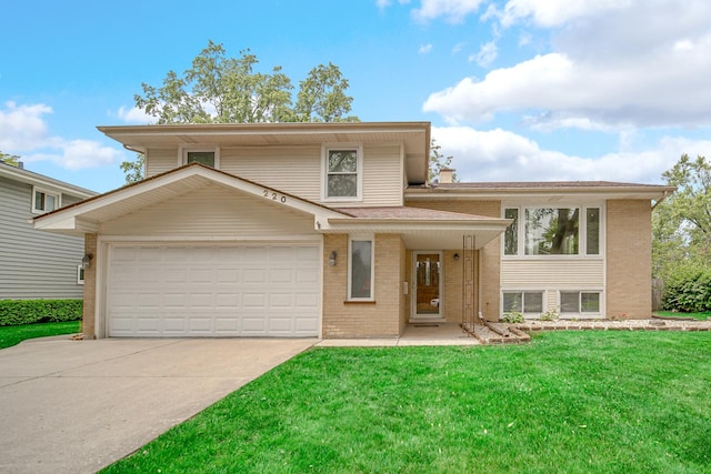 220 N Yates Ln, Mount Prospect, IL 60056 - tri-level home with brick siding, a front yard, and driveway