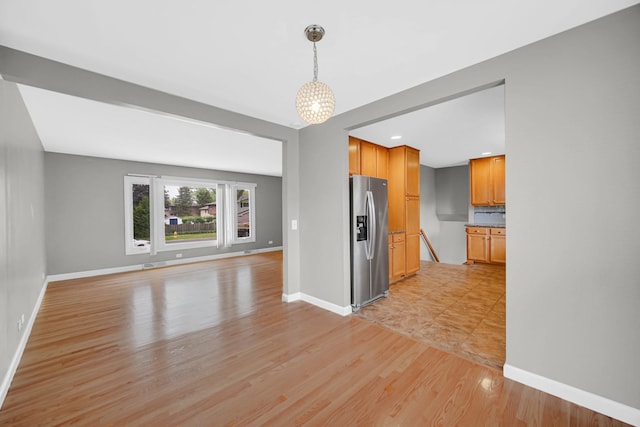220 N Yates Ln, Mount Prospect, IL 60056 - unfurnished living room featuring a chandelier and light wood-type flooring