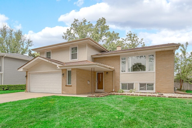 220 N Yates Ln, Mount Prospect, IL 60056 - split level home featuring concrete driveway, brick siding, a chimney, and an attached garage
