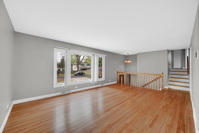 220 N Yates Ln, Mount Prospect, IL 60056 - spare room featuring a chandelier and light wood-style flooring