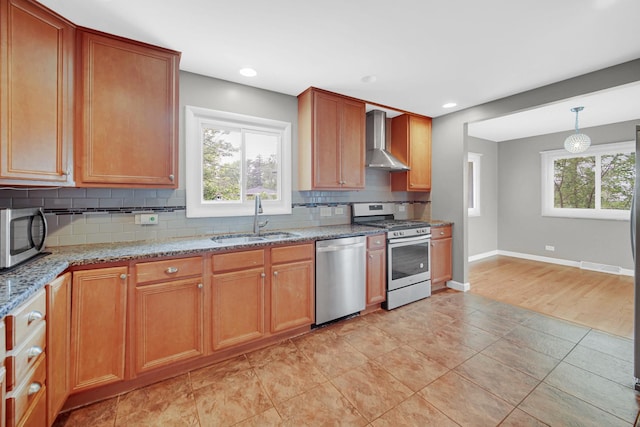 220 N Yates Ln, Mount Prospect, IL 60056 - kitchen with appliances with stainless steel finishes, wall chimney range hood, tasteful backsplash, light stone countertops, and recessed lighting