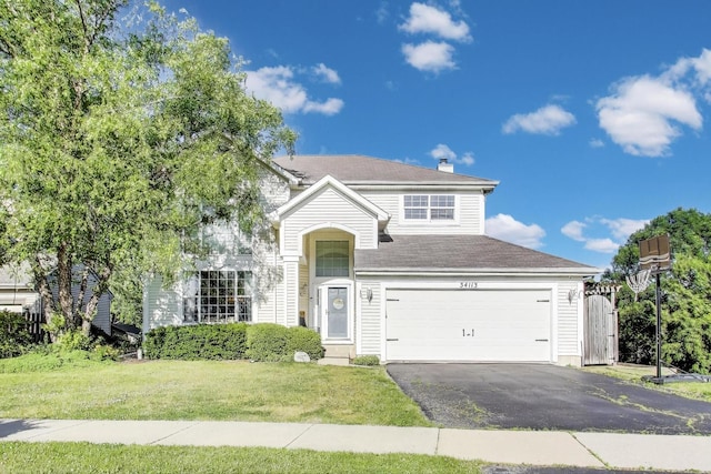 34113 N Primrose Ct, Round Lake, IL 60073 - traditional-style house with a front yard, asphalt driveway, a garage, and roof with shingles