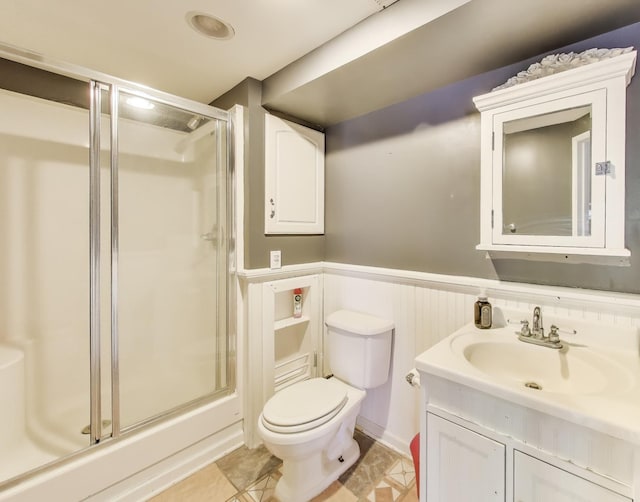 34113 N Primrose Ct, Round Lake, IL 60073 - bathroom featuring a stall shower, vanity, a wainscoted wall, and tile patterned floors