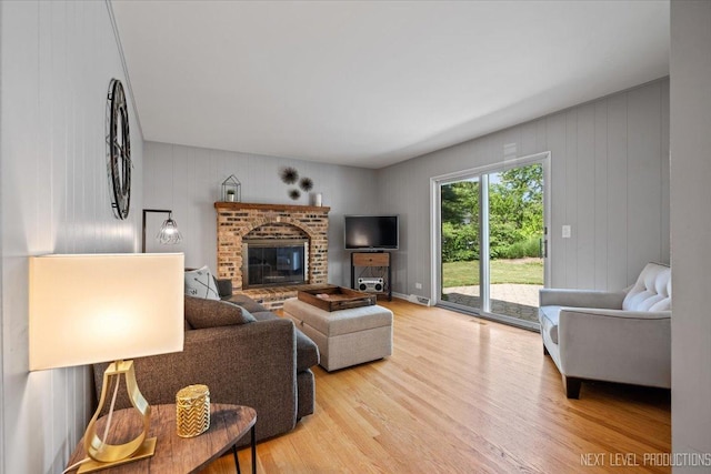 1009 E Bailey Rd, Naperville, IL 60565 - living room with light wood-style flooring and a brick fireplace