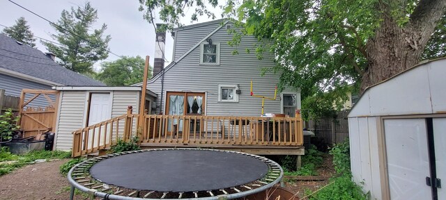316 Clifton Dr, Round Lake Park, IL 60073 - back of property featuring a trampoline, a shed, and a deck