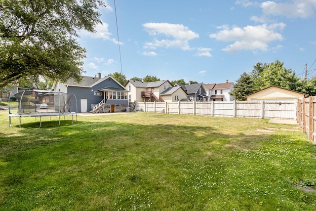 408 Summit St, Joliet, IL 60435 - fenced backyard featuring a trampoline, stairway, and a wooden deck