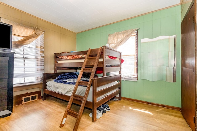 408 Summit St, Joliet, IL 60435 - bedroom featuring wood finished floors, multiple windows, ornamental molding, and wooden walls