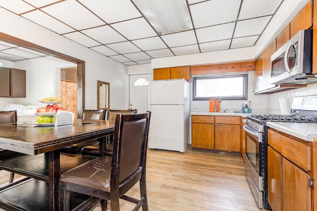 408 Summit St, Joliet, IL 60435 - kitchen with appliances with stainless steel finishes, washer and clothes dryer, light countertops, healthy amount of natural light, and a paneled ceiling
