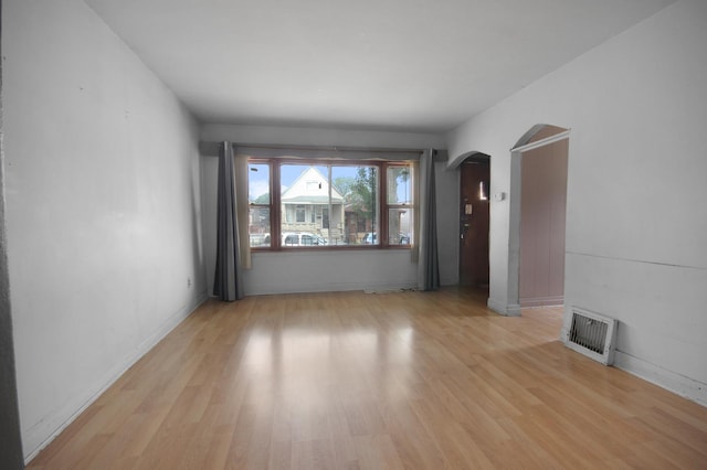 10445 S S Ave H, Chicago, IL 60617 - empty room featuring arched walkways and light wood-type flooring