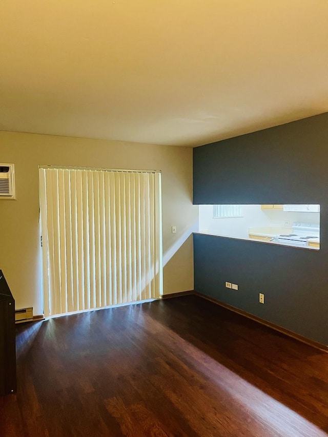 1335 N Winslowe Dr Unit 304, Palatine, IL 60074 - empty room featuring wood finished floors, a baseboard radiator, and an AC wall unit