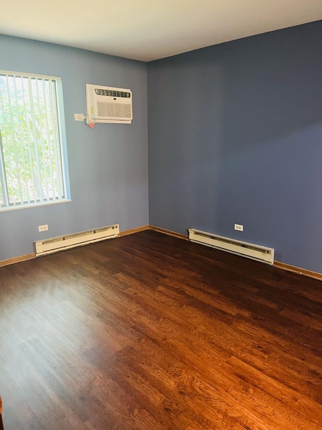 1335 N Winslowe Dr Unit 304, Palatine, IL 60074 - spare room featuring a baseboard radiator, a wall unit AC, and wood finished floors