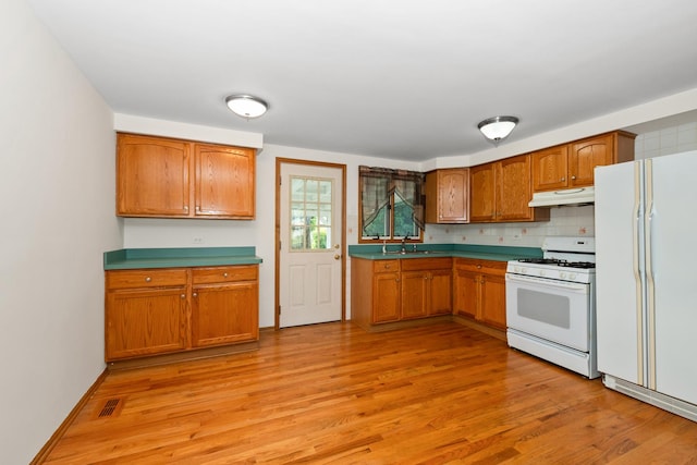 8928 S Ryan Rd, Hometown, IL 60456 - kitchen featuring white appliances, under cabinet range hood, light wood-type flooring, and brown cabinets