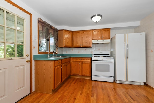 8928 S Ryan Rd, Hometown, IL 60456 - kitchen featuring white appliances, under cabinet range hood, light wood finished floors, and brown cabinetry