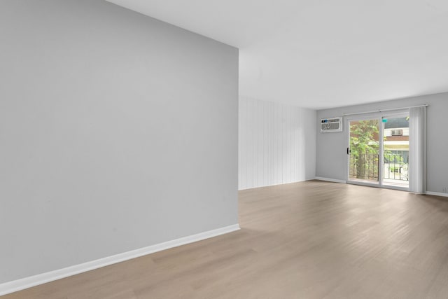 1195 Meadow Ln Unit 213, Hoffman Estates, IL 60169 - unfurnished room featuring light wood finished floors and a wall mounted air conditioner