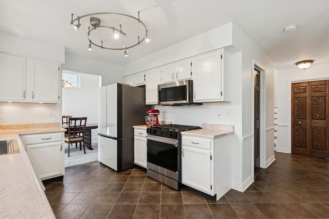 17889 W Elsbury St, Gurnee, IL 60031 - kitchen with appliances with stainless steel finishes, white cabinetry, light countertops, and dark tile patterned floors