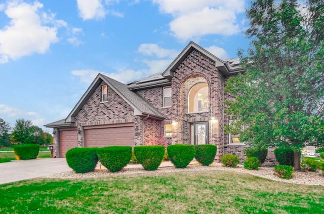 3105 Hermes Dr, Olympia Fields, IL 60461 - traditional-style house featuring brick siding, concrete driveway, a garage, roof mounted solar panels, and a front yard
