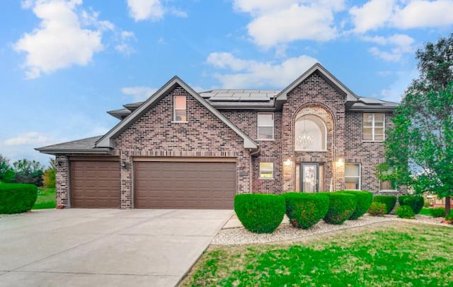 3105 Hermes Dr, Olympia Fields, IL 60461 - traditional-style house featuring roof mounted solar panels, brick siding, driveway, and an attached garage