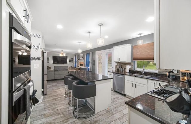 3105 Hermes Dr, Olympia Fields, IL 60461 - kitchen featuring appliances with stainless steel finishes, ceiling fan, open floor plan, a center island, and white cabinets