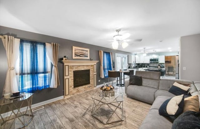 3105 Hermes Dr, Olympia Fields, IL 60461 - living room with ceiling fan, light wood-type flooring, and a fireplace